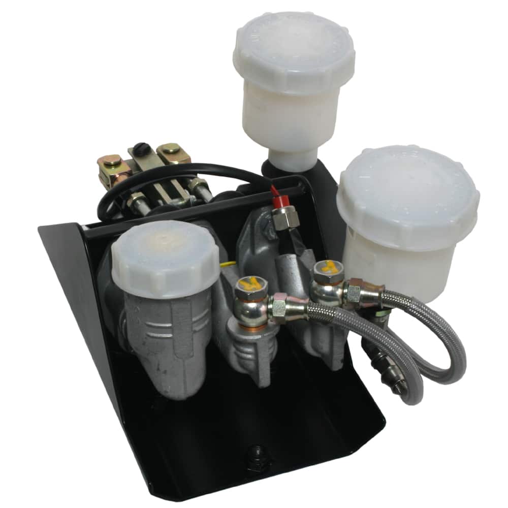 An abs brake module with attached fluid reservoirs, metal fittings, and electrical connections mounted on a black base plate.