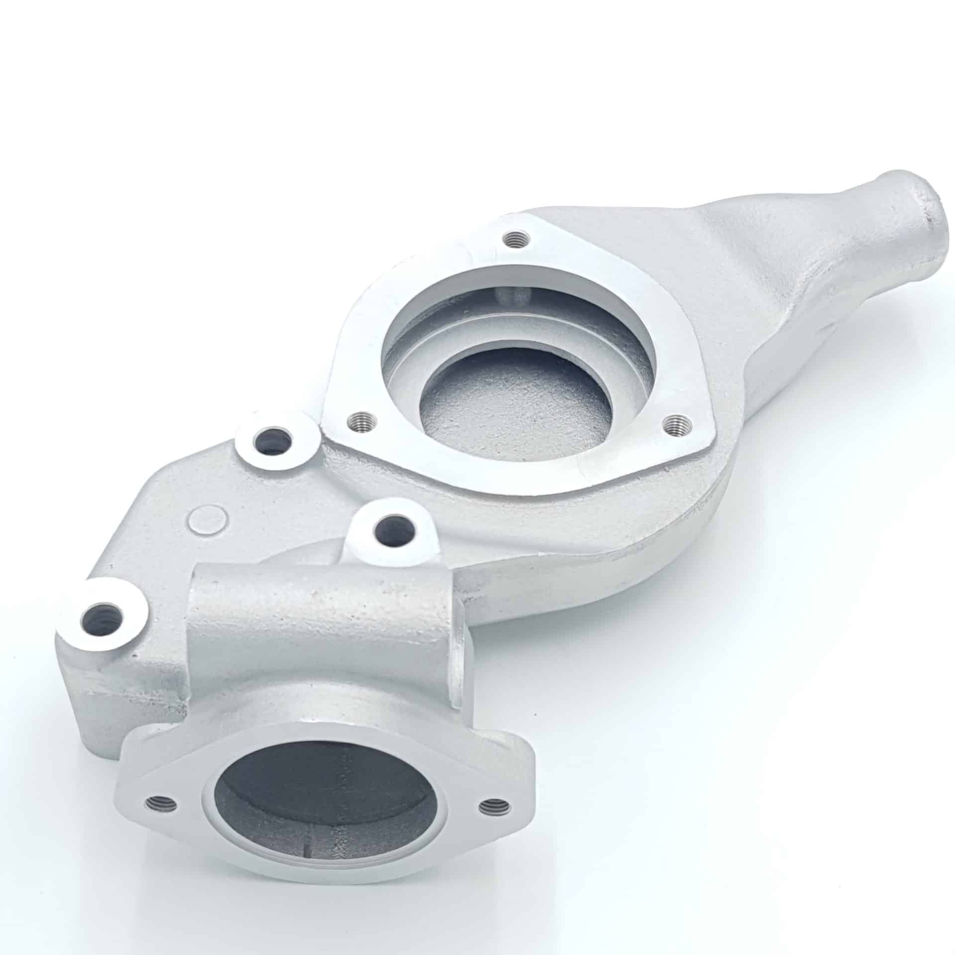 The Racetorations Aluminium Water Pump Housing for Triumph TR5, TR250 & TR6 UPDATED is shown on a white background, featuring silver metal construction with multiple circular openings, flanges, and mounting holes.