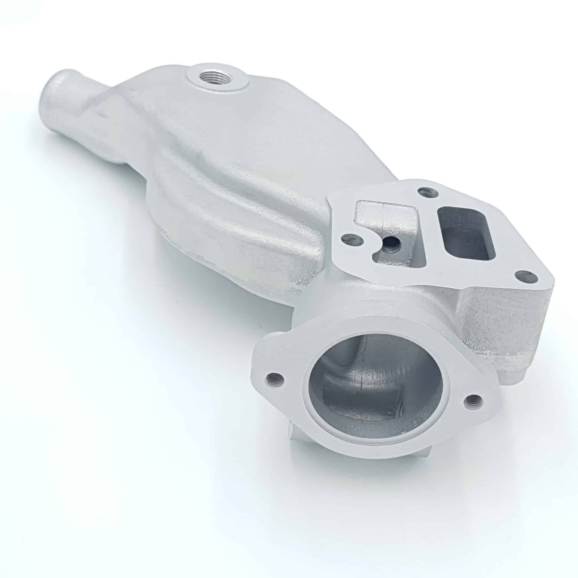 The Racetorations Aluminium Water Pump Housing for Triumph TR5, TR250 & TR6 UPDATED is a silver automotive component featuring multiple openings, bolt holes, and a smooth, curved surface, shown isolated on a white background.