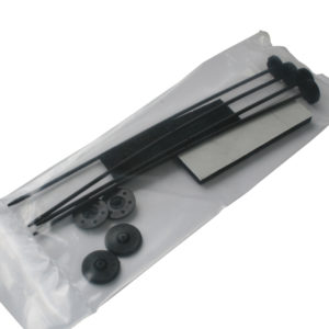A model airplane assembly kit containing black plastic propellers, foam pieces, and small rubber components, all sealed in a clear plastic bag with an Electric Fan Fitting Kit.