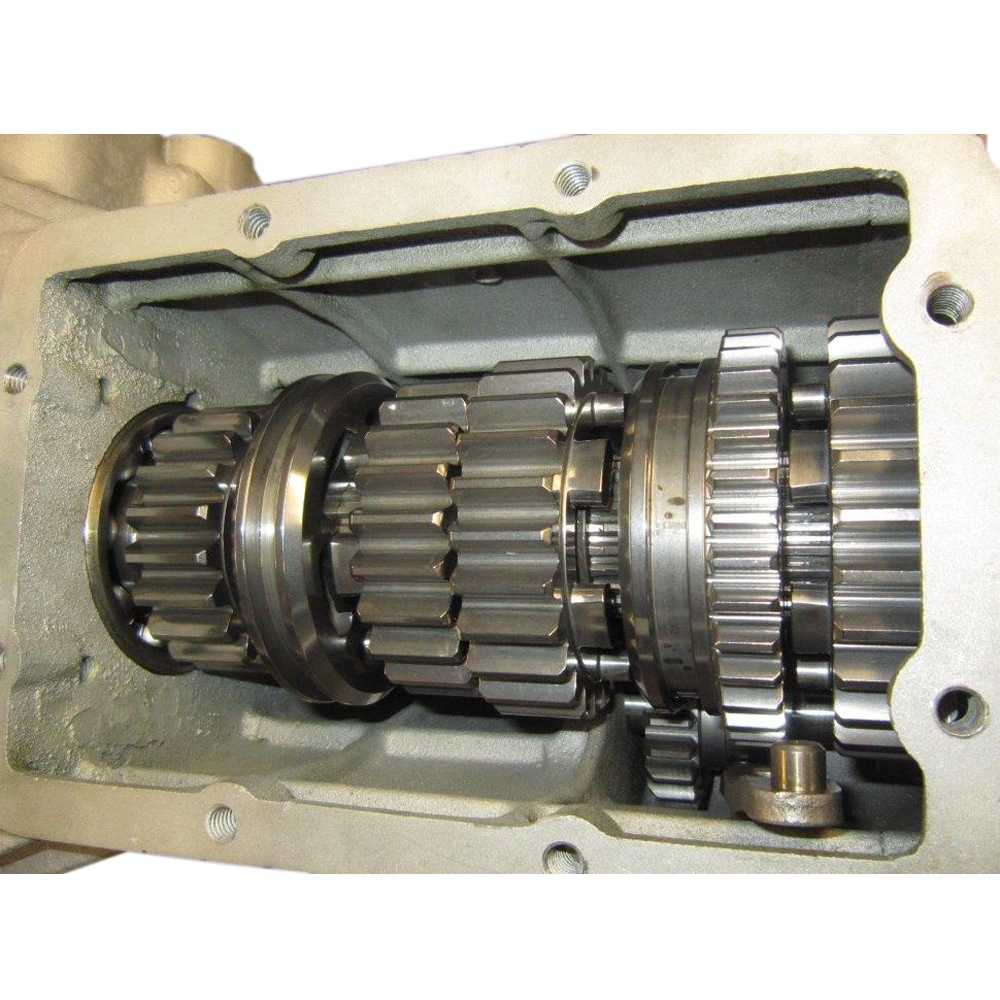 Close-up of the Racetorations Quaife Competition "Dog" Gearbox—TR2-6, displaying clean, well-machined interlocking gears and shafts inside a rectangular casing, engineered for optimal TR2-6 performance.