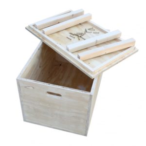 A shipping container for gearboxes partially assembled with its lid open, displaying planks and screws inside for completion, all isolated on a white background.