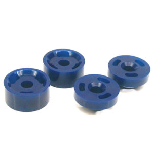 Four blue SuperPro Polyurethane Differential Front Mounting Kit - TR5-6 flanged button hole spacers arranged on a white background.