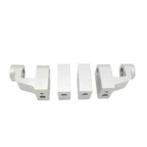 The Aluminium Rocker Pedestal Set - TR2-4A & Morgan +4 includes four silver metal parts with drilled holes and rectangular centre blocks, arranged in a row on a white background—ideal for TR2-4A or Morgan +4 models.