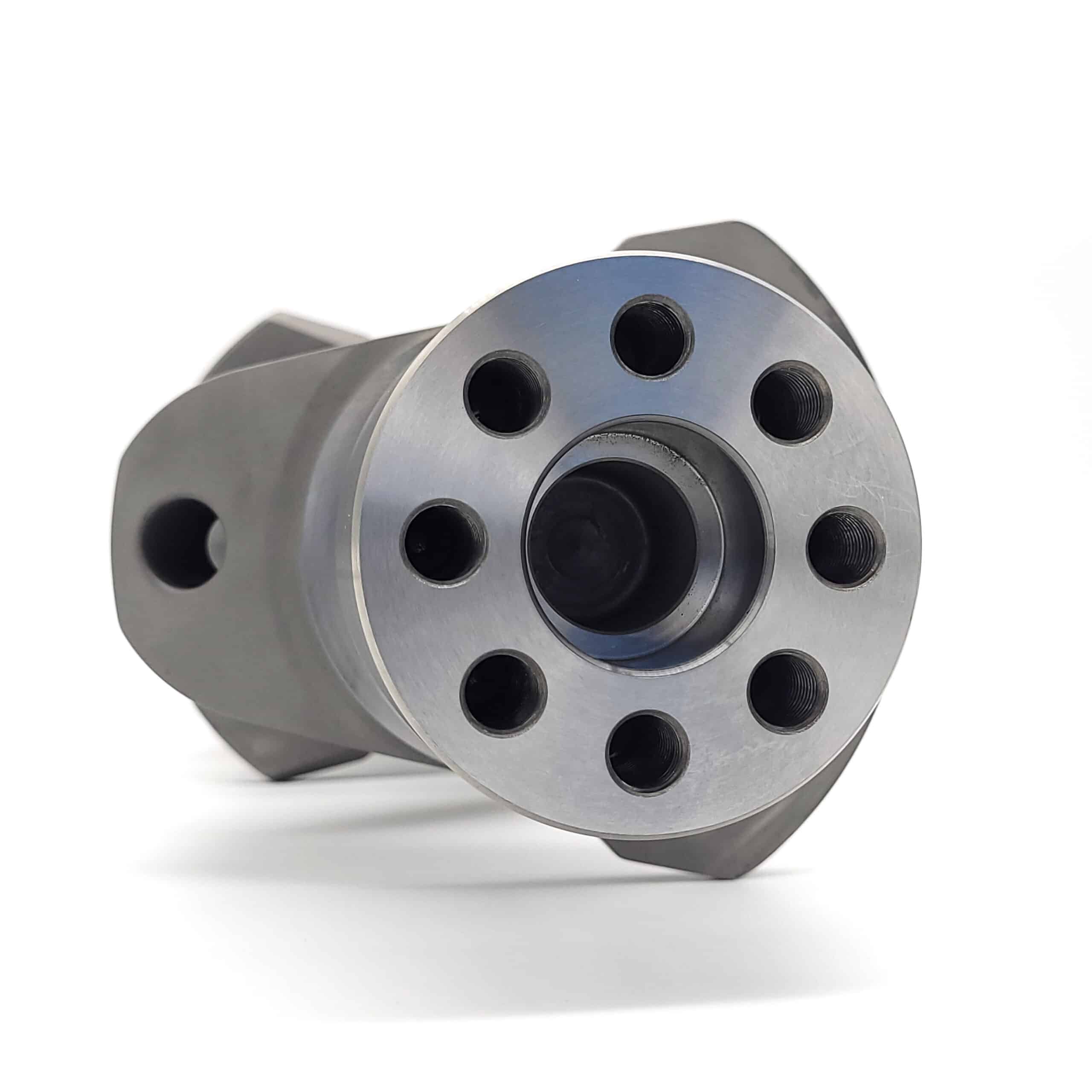 A close-up of an Arrow Precision Engineering Billet Steel Crankshaft, Standard Journal – TR2-4, Morgan +4, showing its cylindrical form with seven evenly spaced holes around a central opening on a white background.