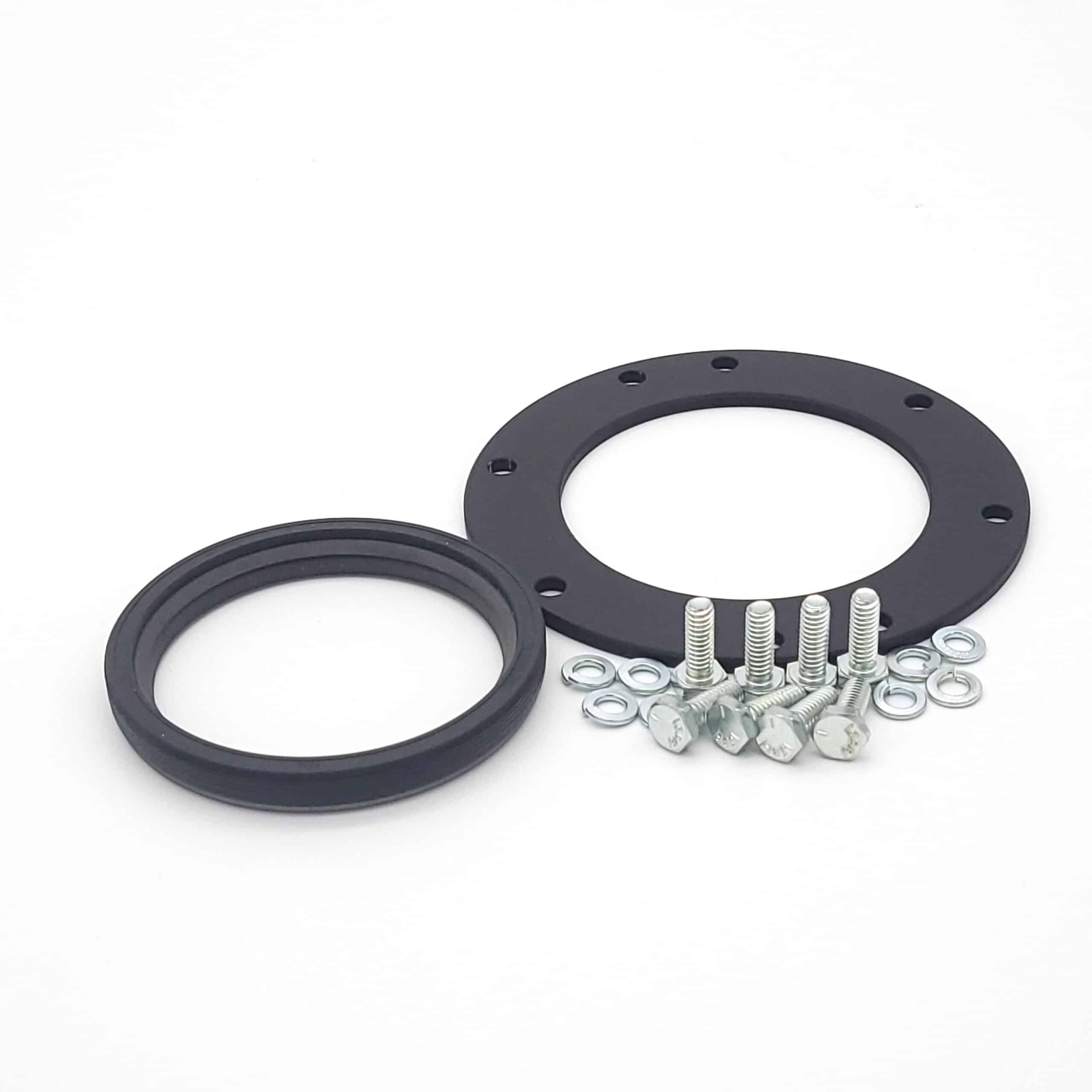 Two black circular metal rings, one perforated, and several silver screws and nuts are displayed on white—components from the Racetorations Billet Steel Crankshaft Seal Housing Kit for TR2-4A & Morgan +4.