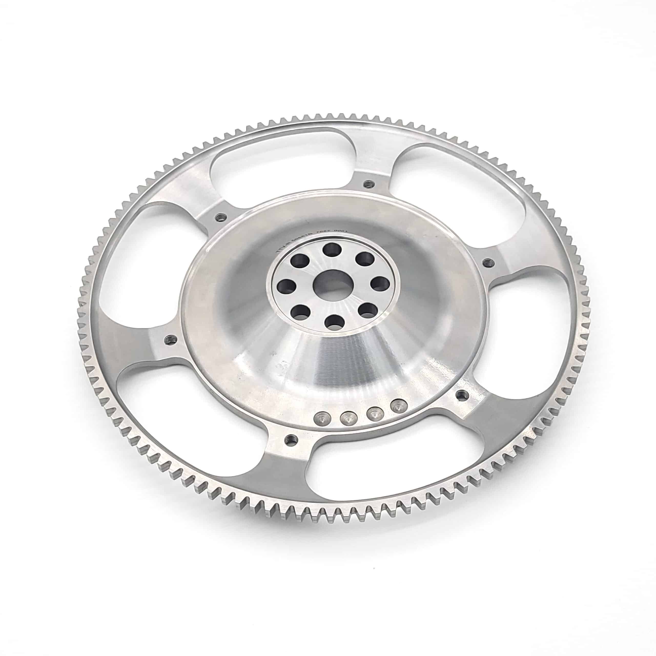 A Racetorations Ultralight One-Piece Steel Flywheel for 7 1/4" clutch (TR5-6) is shown—large, circular, with evenly spaced teeth and multiple central holes—displayed on a plain white background.