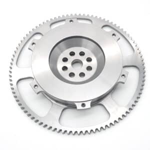 A close-up of the Racetorations Ultralight One-Piece Steel Flywheel with evenly spaced edge teeth and central holes, designed for steel crank, 7¼" clutch, and suitable for TR2-4A & Morgan +4 models on a white background.