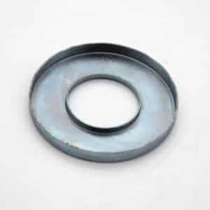 A metallic, circular object with a raised rim and a large hole in the centre, placed on a white background. It appears to be a mechanical or industrial component.