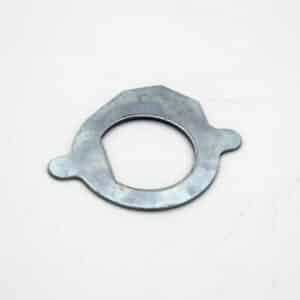 A flat metal washer with an irregular, slightly hexagonal outer shape and two small tab-like extensions on opposite sides, placed on a white background.