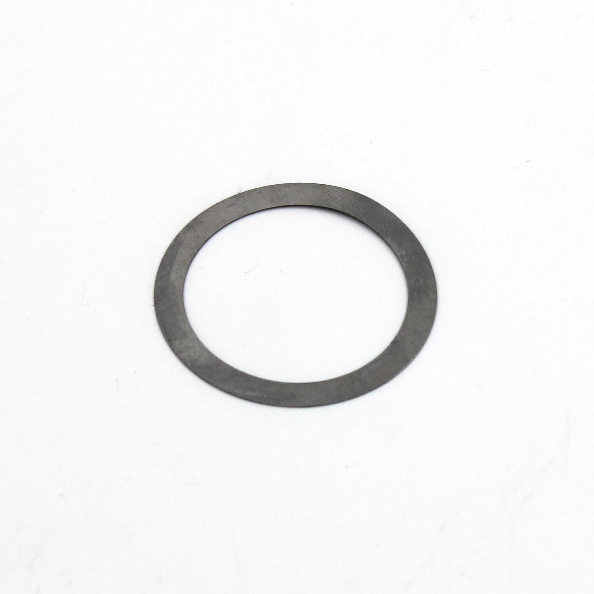A thin, flat, circular metal washer with a large centre hole, placed on a white background.