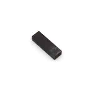 A small, rectangular, solid metal key with dark colouring, placed on a plain white background.