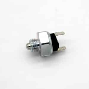 A metal automotive or industrial pressure switch with a threaded body, hex nut, and two flat electrical terminals, isolated on a white background.