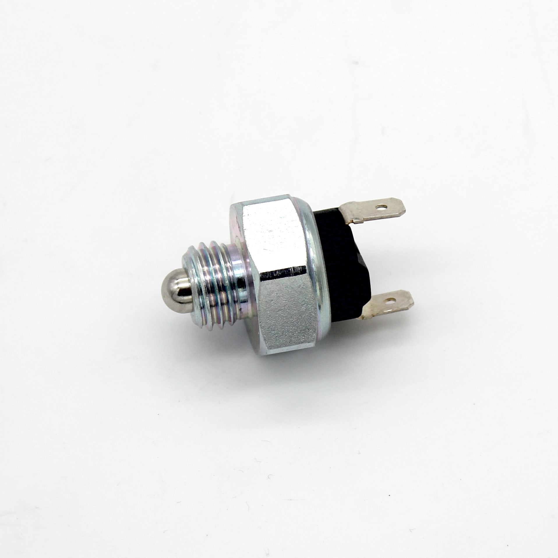 A metal automotive or industrial pressure switch with a threaded body, hex nut, and two flat electrical terminals, isolated on a white background.