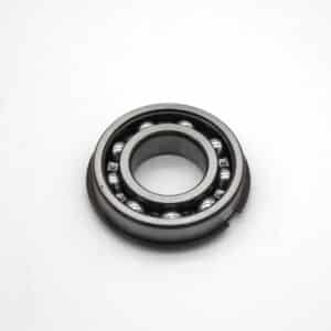A close-up of a metal ball bearing with an inner and outer ring, featuring visible ball bearings inside, placed on a plain white background.