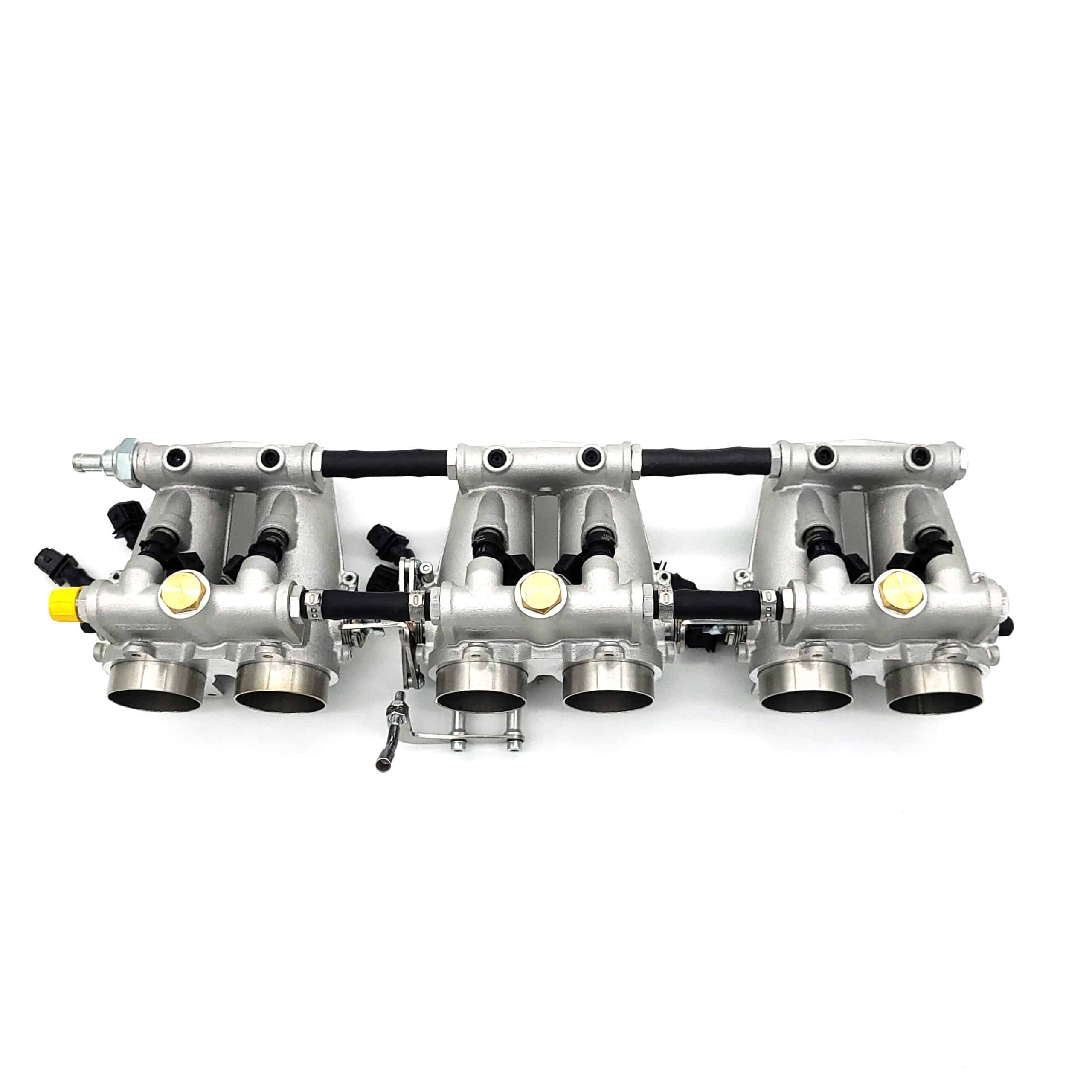 A silver motorcycle throttle body assembly with four intake ports, fuel injectors, and various connectors, displayed on a white background.