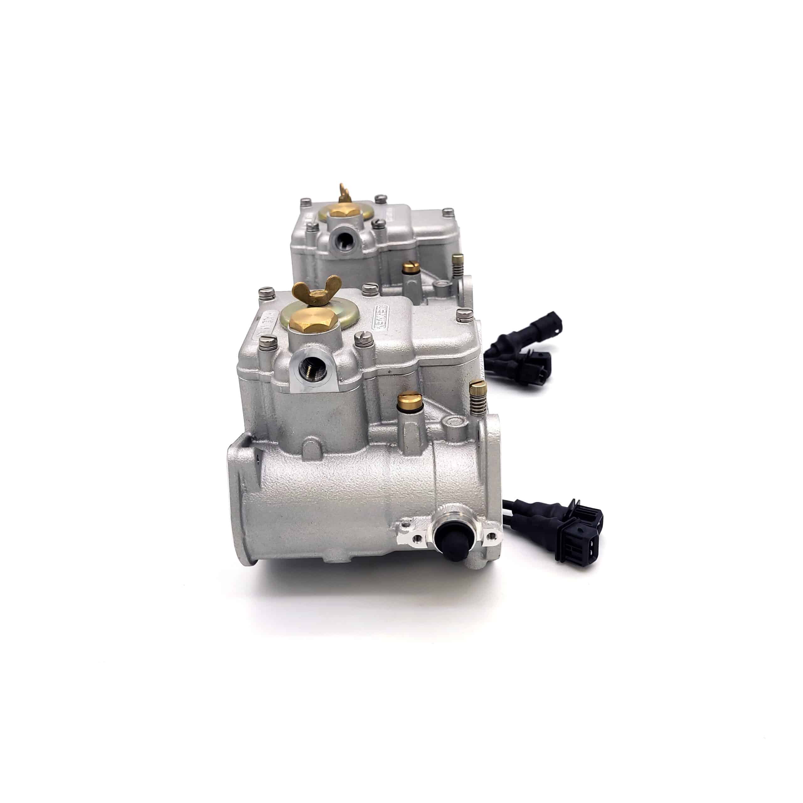 Two Jenvey Heritage Throttle Body Set - TR2-4A components with brass and black fittings are arranged in a row on a white background, each featuring a black electrical connector.