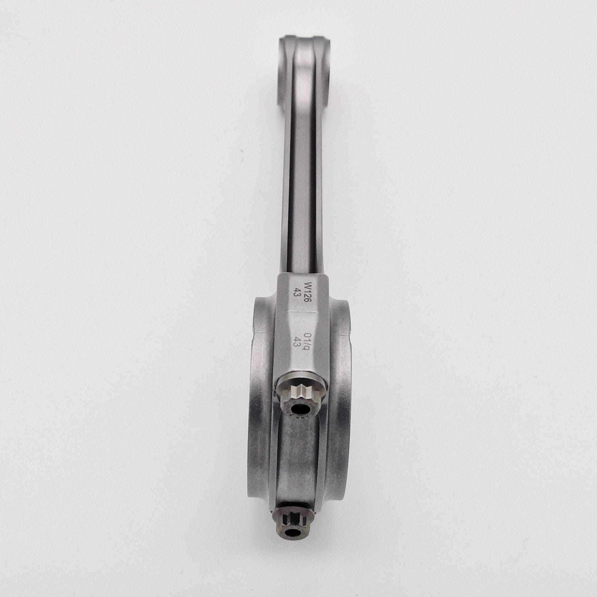 A Racetorations 87mm Slipper Piston & Steel Connecting Rod Set for TR2-4A & Morgan +4 is shown vertically on a plain white background, highlighting the side profile and gear-like ends suited for slipper piston use.