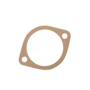 A flat, brown, circular Pedestal Shim Gasket 0.006" with two bolt holes on opposite sides, likely made of compressed fibre or cardboard material—suitable for use on classic models such as the Triumph TR5 and TR6.