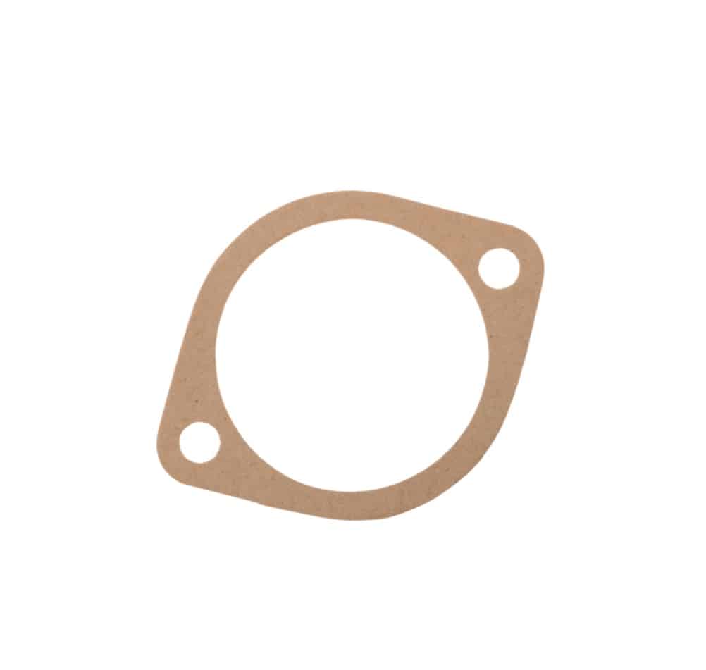 A flat, brown, circular Pedestal Shim Gasket 0.006" with two bolt holes on opposite sides, likely made of compressed fibre or cardboard material—suitable for use on classic models such as the Triumph TR5 and TR6.