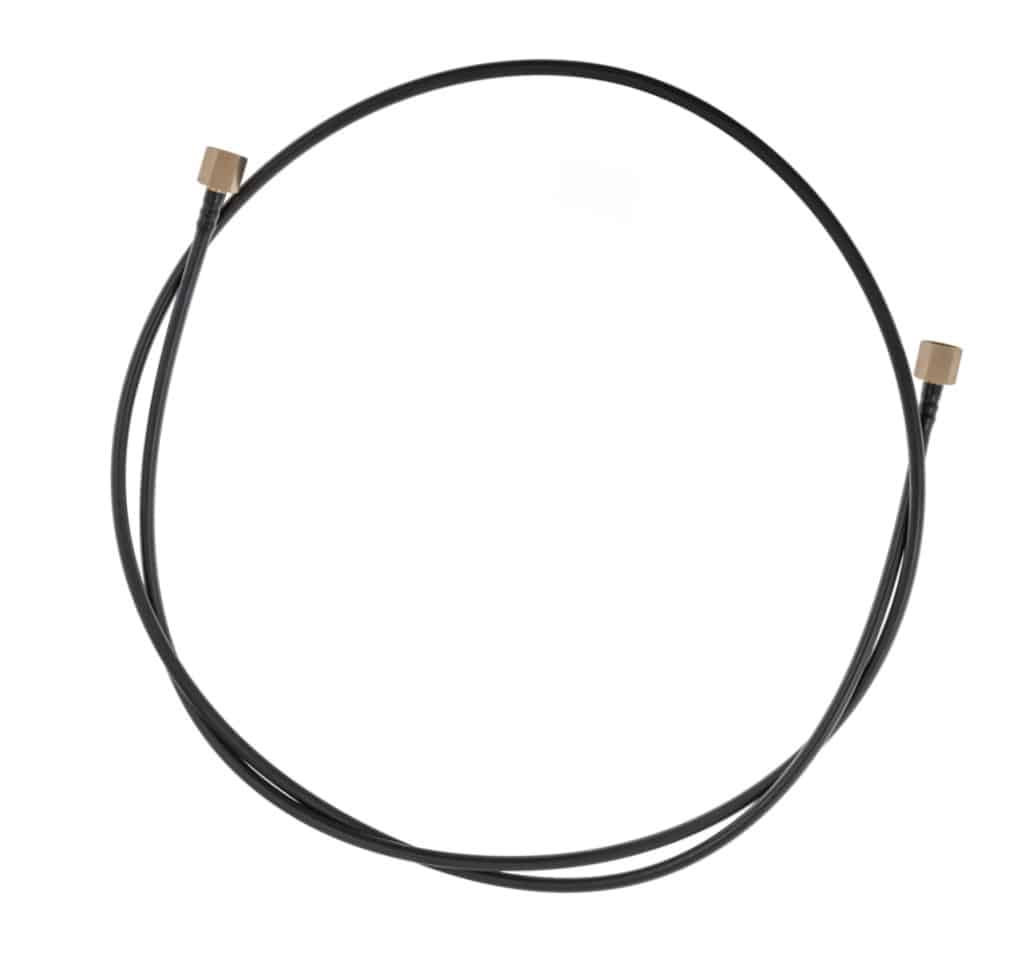 An Oil Pipe Engine to Gauge for Triumph TR5 and TR6 Petrol Injection models, featuring a black cable with metal connectors at both ends, is displayed coiled in a loose circle on a white background.