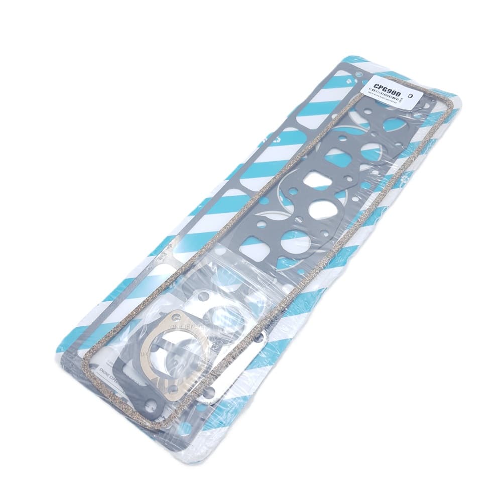 A packaged Payen Triumph TR5, TR250, and TR6 Head Gasket Set for Flat Top Block, containing multiple gaskets of different shapes and sizes, wrapped in clear plastic and displayed on a blue and white striped backing.