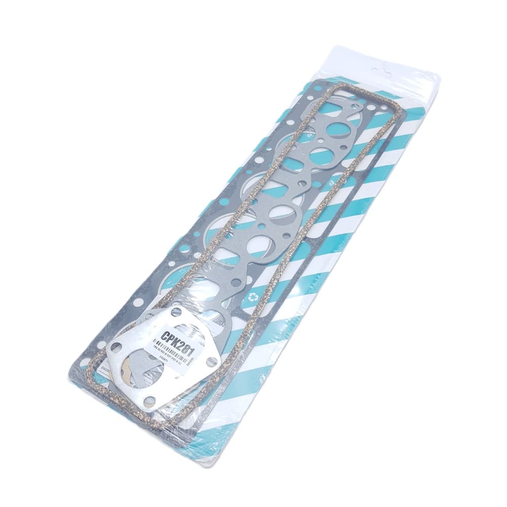 The Payen Triumph TR6 Head Gasket Set for Recessed Top Block comes packaged with multiple gaskets—including a large metal head gasket designed for recessed top blocks, as well as thinner cork and fibre gaskets—all neatly arranged on blue-and-white striped backing.