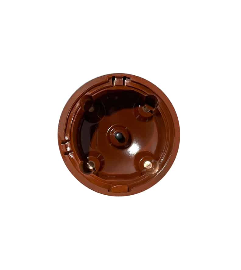 A Red plastic 123ignition Distributor Cap viewed from above, showing contacts and a circular rim, on a white background. essential as the 123ignition 4 Cylinder Replacement Distributor Cap is to keeping your classic car running smoothly.