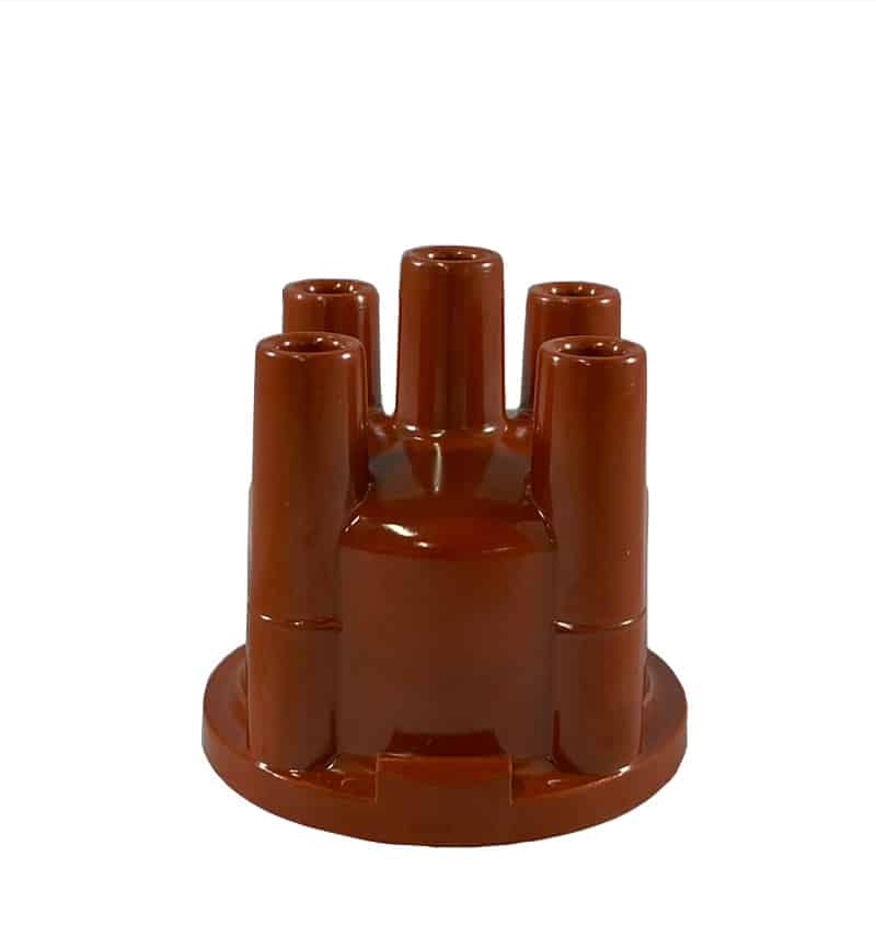 A red cylindrical 123ignition 4 Cylinder Replacement Distributor Cap made of plastic, featuring multiple vertical tubes arranged in a circular pattern on a round base, reminiscent of classic distributor caps used in 123 Ignition systems.