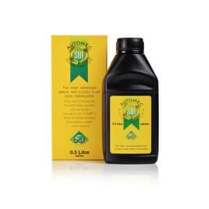 A black bottle of Silicone Brake & Clutch Fluid Dot 5 - 500 ml next to its yellow box, both featuring labels with product details and a green logo.